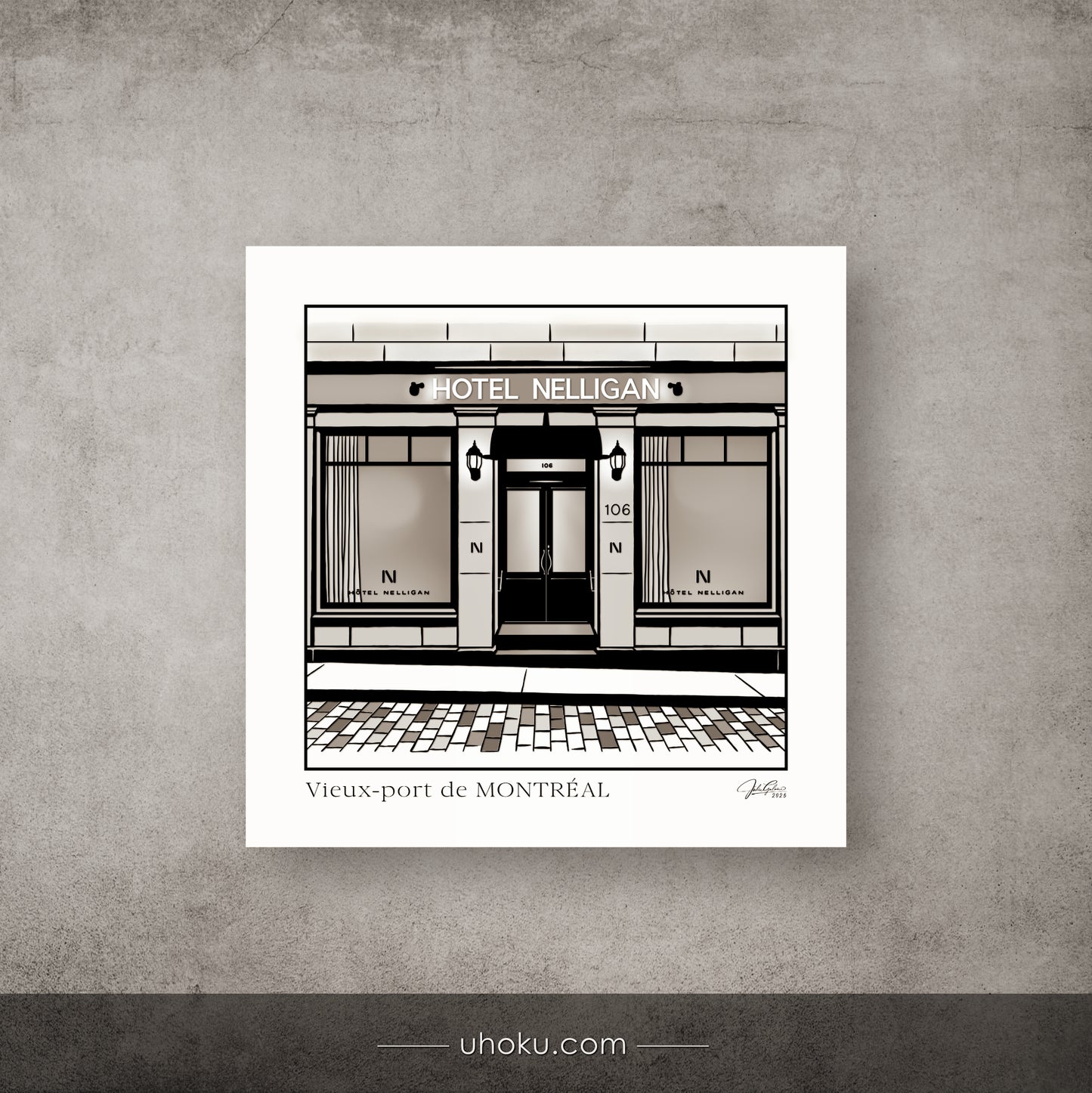 Framed black and white print of Hotel Nelligan in Montreal on a textured gray wall.